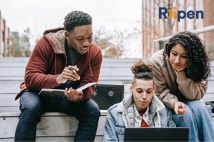 students looking at a laptop. 